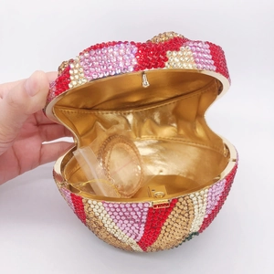 Macro view of heart-shaped clutch interior with golden lining and detachable metal chain
