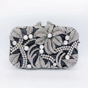 Detail view of silver crystal floral pattern on hollowed out evening clutch bag