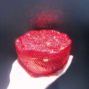 Detail of red rhinestone lips clutch purse featuring a secure gold metallic clasp