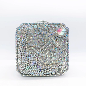 Macro shot of anchor-shaped crystal pattern on rhinestone evening clutch with iridescent finish