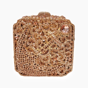 Close-up of champagne gold rhinestones and intricate patterns on the square clutch bag