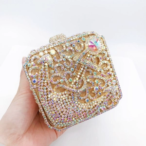 Close-up of luxury gold evening clutch bag with intricate crystal and diamond patterns