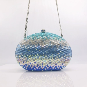 Detail of blue gradient rhinestone clutch featuring wave patterns and silver chain