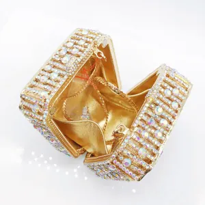 Macro view of champagne gold clutch with crystal diamond surface and chain strap