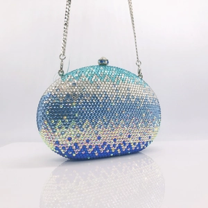 Detailed macro shot of blue gradient rhinestones on a luxury oval evening clutch bag