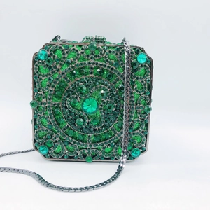 Macro shot of green crystal evening clutch bag with intricate emerald geometric patterns