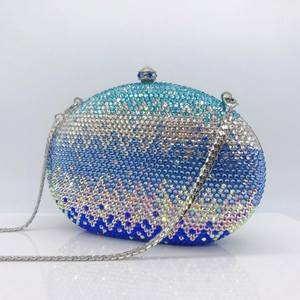Close-up of sparkling blue gradient rhinestone evening clutch bag with metal chain