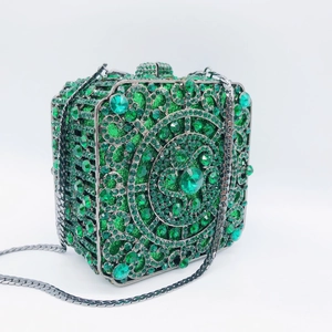Detailed close-up of a green crystal evening clutch with spiral geometric patterns