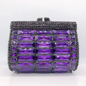 Macro view of purple rhinestone clutch with rectangular crystals and diamond closure