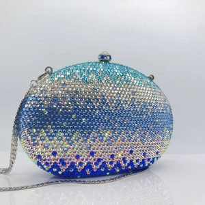 Detail of gradient blue rhinestone evening clutch with crystal wave patterns and silver chain