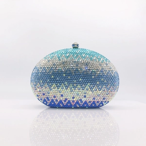 Close-up of a gradient blue and silver rhinestone clutch with luxury spherical metal clasp