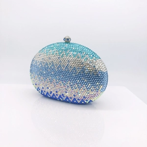 Macro detail of gradient blue rhinestones and silver spherical clasp on evening clutch bag