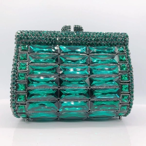 Detailed macro of a green luxury evening clutch with densely set sparkling emerald rhinestones