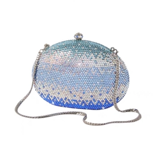 Macro detail of gradient blue and white rhinestones on oval hard shell evening clutch
