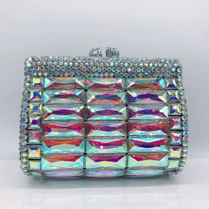 Close-up of luxury evening clutch with colorful gradient rhinestones and metal clasp