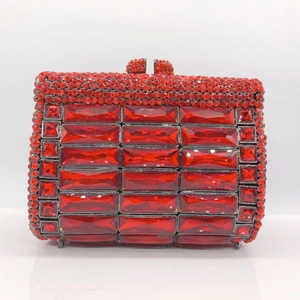 Detail of red rhinestone clutch purse with rectangle crystals and black metal frame