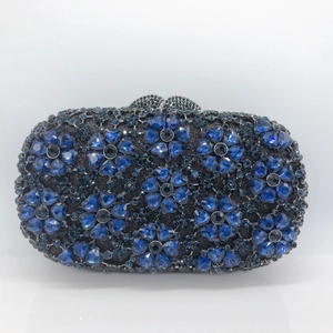 Macro view of blue floral rhinestone pattern and crystal inlay on luxury evening clutch bag