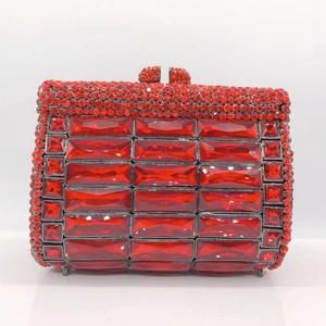 Detailed macro of red rhinestone evening clutch with crystal studs and rectangular gemstones