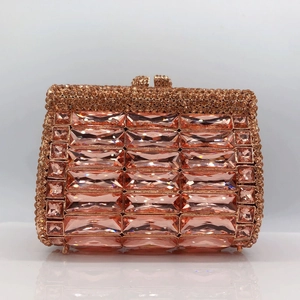 Close-up of champagne pink rhinestone clutch purse with rectangle crystals and metal frame