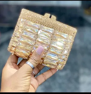 Close-up of golden rectangular rhinestone clutch purse featuring dense crystal inlay