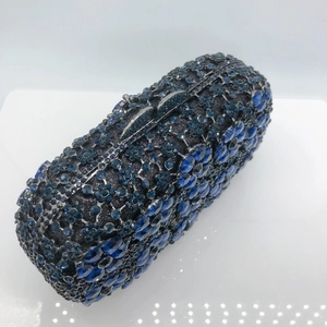 Macro detail of navy blue rhinestone evening bag with intricate crystal floral patterns