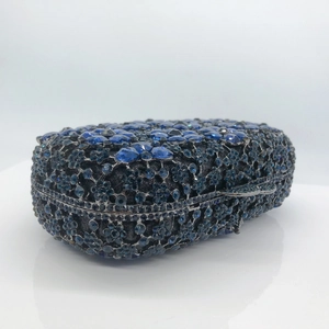 Detailed macro shot of deep blue crystal floral pattern on luxury evening clutch handbag
