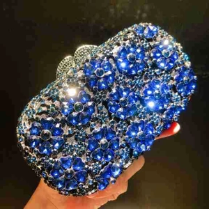 Detail of blue heart flower rhinestone evening clutch bag with sparkling floral pattern