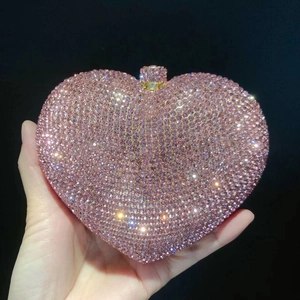 Close-up of pink heart-shaped crystal evening clutch with sparkling rhinestones