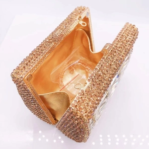 Detail of champagne gold rhinestone evening clutch bag with silk lining and chain strap