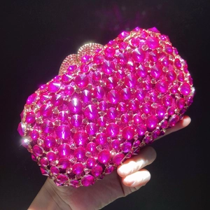 Macro shot of rose red crystal handbag with sparkling hand-set rhinestones for gala