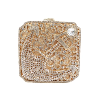 Luxurious gold evening clutch bag with intricate crystal rhinestones and floral patterns