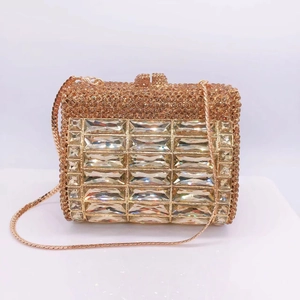 Macro view of luxury champagne gold clutch with rectangular glass rhinestones and chain