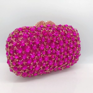 Macro view of rose pink rhinestone clutch with sparkling crystals and metal frame