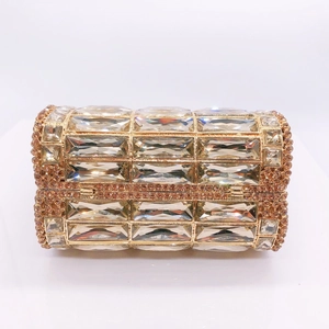 Detail of champagne rhinestone clutch showing crystal settings and gold metal frame