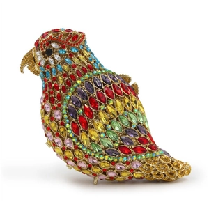 Detailed close-up of parrot clutch bag featuring multi-colored crystals and gold metal frame