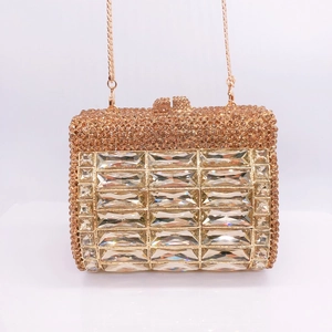 Detail of champagne gold evening clutch with rhinestones and rectangular crystals