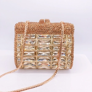 Detailed macro view of luxury champagne gold evening clutch with radiant crystal mesh texture