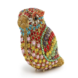 Macro shot of colorful rhinestones on a parrot shaped metal evening clutch bag