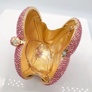 Pink heart-shaped evening clutch with crystal rhinestones and a gold chain strap