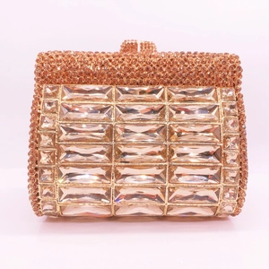 Close-up of champagne gold rhinestone clutch with large crystals and gemstone clasp