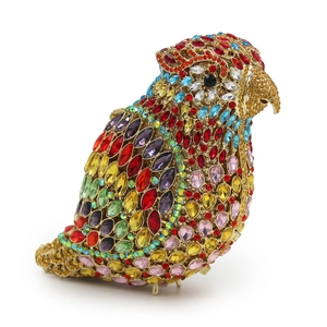 Macro view of crystal-encrusted parrot bird clutch bag with colorful rhinestones