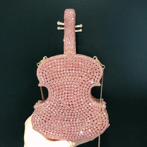 Violin shaped evening clutch bag encrusted with pink rhinestones and gold chain strap
