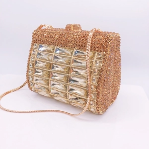 Detailed close-up of champagne rhinestone evening clutch with emerald-cut crystals