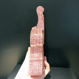 Side view of pink violin-shaped evening clutch bag with sparkling rhinestones details
