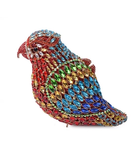 Macro detail of bird-shaped evening bag showing intricate multi-color rhinestone inlay