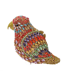 Detailed close-up of a bird-shaped evening clutch bag with colorful rhinestones