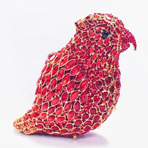 Macro detail of red rhinestone encrusted parrot evening clutch bag with metal base feet