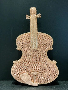Detailed close-up of rose gold rhinestone violin evening clutch bag with intricate crystals