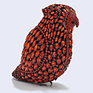 Macro detail of high-quality red crystal rhinestones on the parrot evening clutch bag