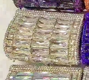 Macro detail of luxury rhinestone clutch purse featuring emerald-cut crystal settings